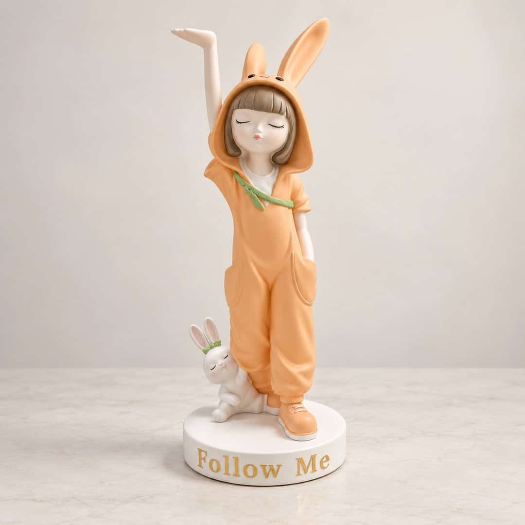 bunny-hood girl figurine in a peach outfit standing beside a small rabbit companion