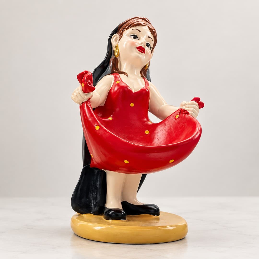 retro woman figurine in a glossy red dress with black shoes on a light tabletop
